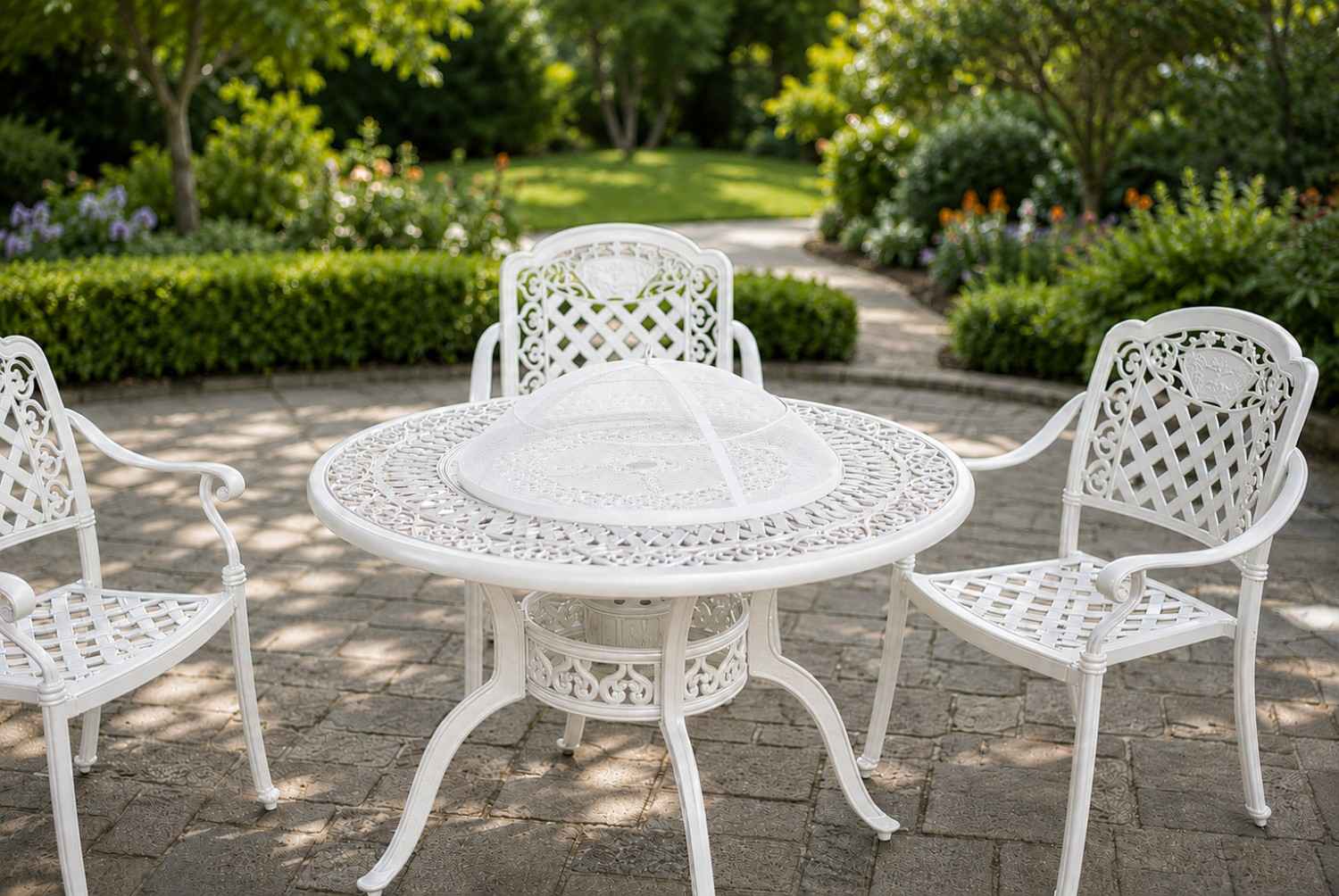 White outdoor table and chairs in a garden