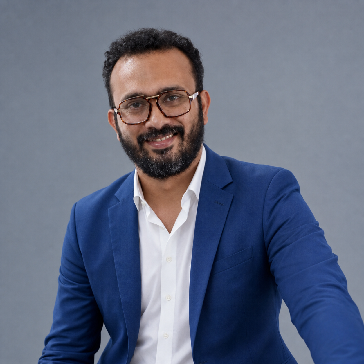 Dr. Ravi Shankar in a blue suit